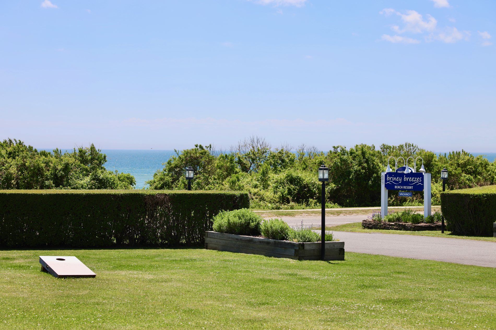 The lawn with games and the Briney Breezes sign above the ocean